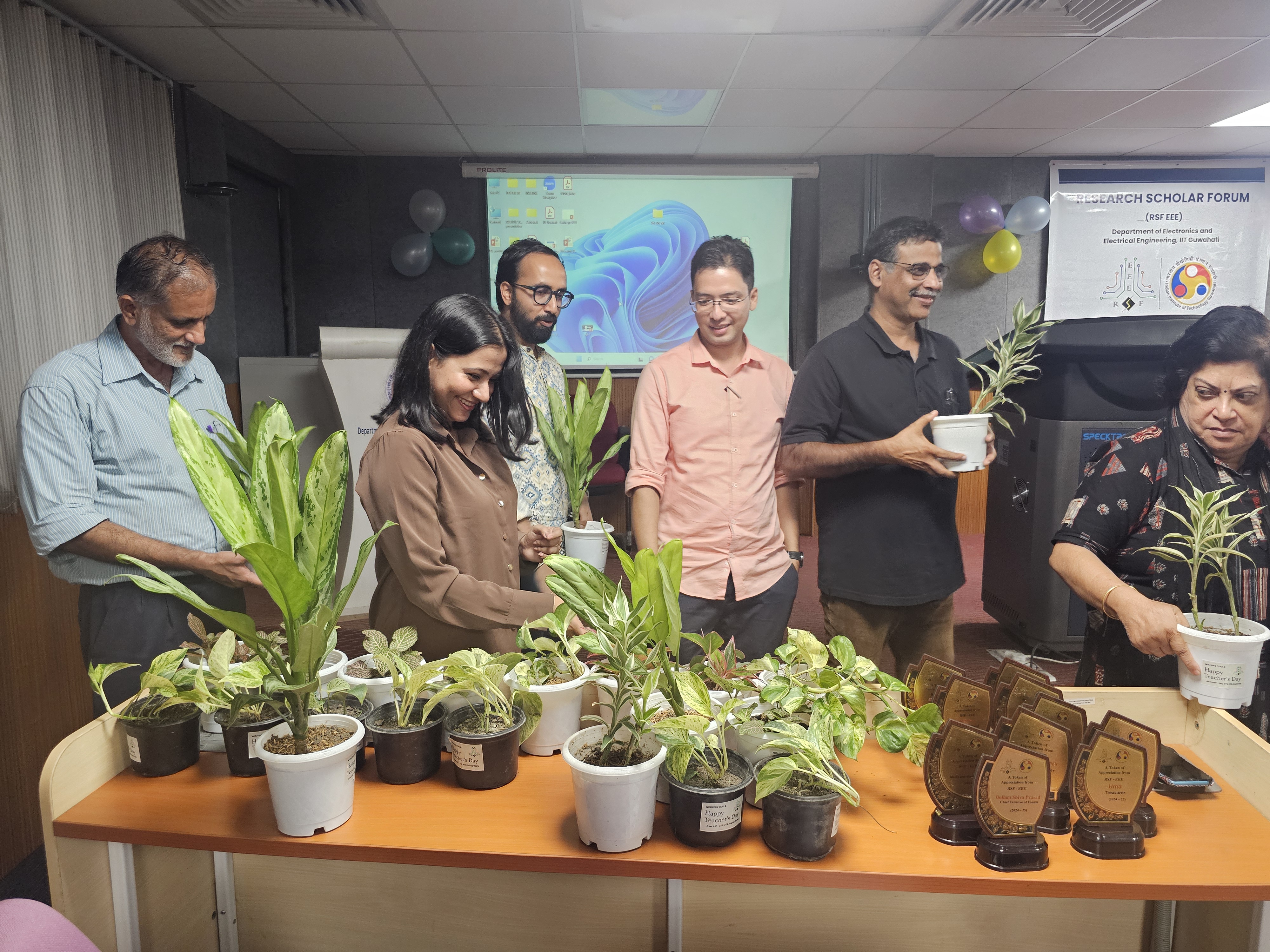 Faculty member receiving a plant